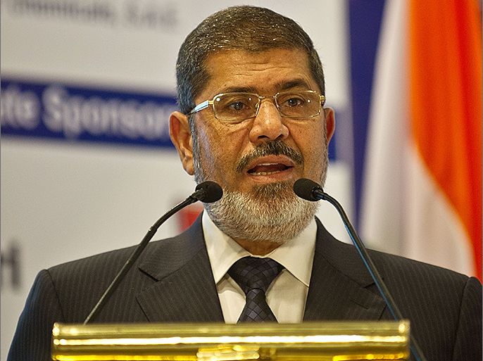 Egyptian President Mohamed Morsi addresses a gathering during India-Egypt Economic Forum in New Delhi on March 20, 2013. Egyptian President Mohamed Morsi called for an urgent halt to the "bloodshed" in Syria after holding talks with Indian leaders in New Delhi.Morsi, who arrived in India late Monday for a two-day visit, told reporters that the global community must work together to end the "bloodshed in Syria and find a peaceful solution". AFP PHOTO/ MANAN VATSYAYANA