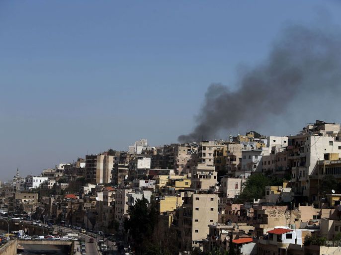 Tripoli, -, LEBANON : Smoke billows from Bab el-Tebbaneh neighborhood during clashes between pro and anti Syrian President Bashar al-Assad in the northern city of Tripoli on March 22, 2013. Tripoli has been rocked by deadly clashes between supporters and opponents of the Damascus regime, where a two-year conflict has killed at least 70,000 people according to UN estimates. AFP PHOTO/JOSEPH