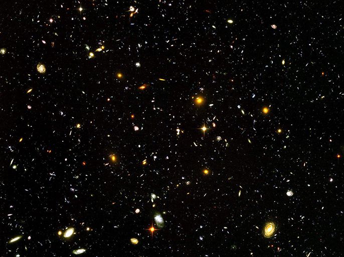 epa00150293 Astronomers at the Space Telescope Science Institute unveiled the deepest portrait of the visible universe ever achieved in this image released Tuesday 09 March 2004 taken by Hubble's Advanced Camera for Surveys (ACS) and the Near Infrared Camera and Multi-object Spectrometer (NICMOS). The image reveals the first galaxies to emerge from the so-called 'dark ages,' the time shortly after the big bang. EPA/NASA