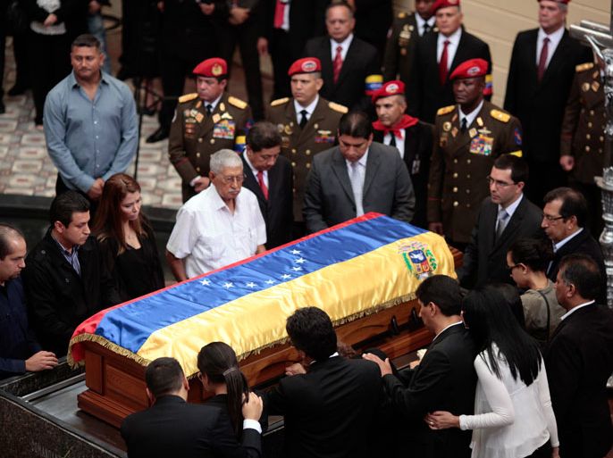 Handout picture released by the Venezuelan presidency showing relatives of late Venezuelan President Hugo Chavez surrounding his coffin upon its arrival at a temporary resting place in the former "4 de Febrero" barracks -- a barracks-turned-museum that the former paratrooper had used as his headquarters during a failed 1992 coup attempt -- in Caracas, on March 15, 2013. Hundreds of thousands of Venezuelans thronged the streets of Caracas on Friday to bid a final farewell to the late leader a month before elections to pick his successor. The Caracas military academy, where Chavez's casket has been on view, served as the starting point for the procession escorting the remains of the 58-year-old, who last week succumbed to cancer after 14 years in power. AFP