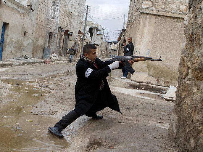 A Syrian rebel aims his weapon during clashes with government forces in the streets near Aleppo international airport in northern Syria on March 4, 2013. Syria is locked in a nearly two-year-old conflict in which the United Nations estimates that more than 70,000 people have been killed. AFP PHOTO/STEPHEN J. BOITANO