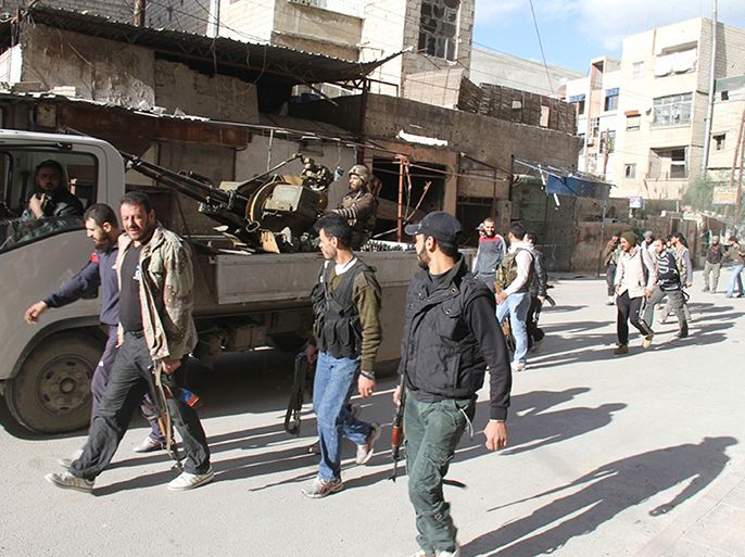 Armed Free Syrian Army fighters walk on a street in Sayed Makdad in Damascus, in this picture provided by Shaam News Network and taken March 23, 2013. Picture taken March 23, 2013. REUTERS/Ward Al-Keswani/Shaam News Network/Handout (SYRIA - Tags: POLITICS CONFLICT) ATTENTION EDITORS - THIS PICTURE WAS PROVIDED BY A THIRD PARTY. REUTERS IS UNABLE TO INDEPENDENTLY VERIFY THE AUTHENTICITY, CONTENT, LOCATION OR DATE OF THIS IMAGE. FOR EDITORIAL USE ONLY. NOT FOR SALE FOR MARKETING OR ADVERTISING CAMPAIGNS. THIS PICTURE IS DISTRIBUTED EXACTLY AS RECEIVED BY REUTERS, AS A SERVICE TO CLIENTS