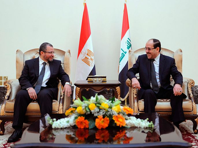 Iraq's Prime Minister Nuri al-Maliki (R) speaks with Egypt's Prime Minister Hisham Qandil during his visit to Baghdad, in this March 4, 2013 picture provided by Iraqi Prime Minister Media Office. REUTERS/Iraqi Prime Minister Media Office/Handout (IRAQ - Tags: POLITICS) ATTENTION EDITORS - THIS IMAGE WAS PROVIDED BY A THIRD PARTY. FOR EDITORIAL USE ONLY. NOT FOR SALE FOR MARKETING OR ADVERTISING CAMPAIGNS. THIS PICTURE IS DISTRIBUTED EXACTLY AS RECEIVED BY REUTERS, AS A SERVICE TO CLIENTS