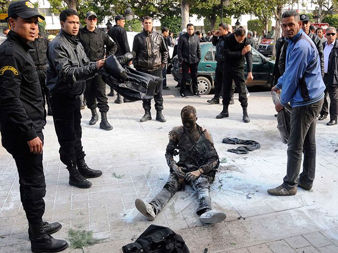 The body of a jobless young Tunisian man, who set himself on fire, is seen at the main street of the capital Tunis in this March 12, 2013 file photo. Protests and strikes planned in Tunisia over the next few weeks will test the government's ability to repair its shaky finances - and may affect its efforts to secure a $1.78 billion loan from the International Monetary Fund. Last week authorities raised most fuel prices for the second time in six months, lifting petrol prices at the pump by 6.8 percent. Taxes on alcohol increased this month, and several weeks ago the state-controlled milk price rose. To match Mideast Money TUNISIA-SUBSIDIES/ REUTERS/Stringer/Files (TUNISIA - Tags: CIVIL UNREST) TEMPLATE OUT