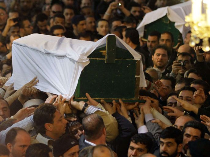 Damascus, -, SYRIA : The coffins of Mohamed Saeed al-Bouti and his grandson Ahmed al-Bouti, who both died in a suicide bomb attack, are carried during their funeral ceremony on March 23, 2013 at the Omayyad mosque in Damascus. The suicide bomb attack in a mosque in Damascus has killed 42 people on March 22