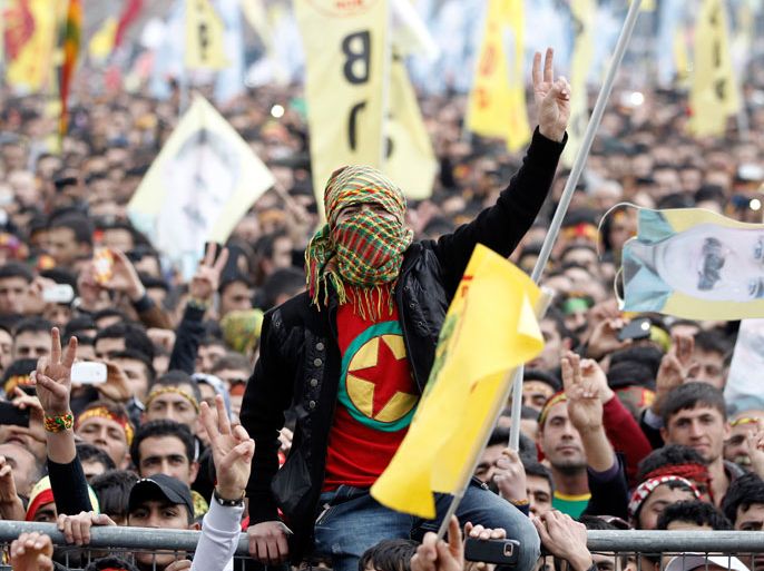 epa03628995 Kurdish people shout slogans as they hold flags of the Peace and Democracy Party (BDP) during Newroz celebrations in Istanbul, Turkey, 17 March 2013. Newroz, which means 'new day' in Kurdish, marks the arrival of spring. EPA/SEDAT SUNA