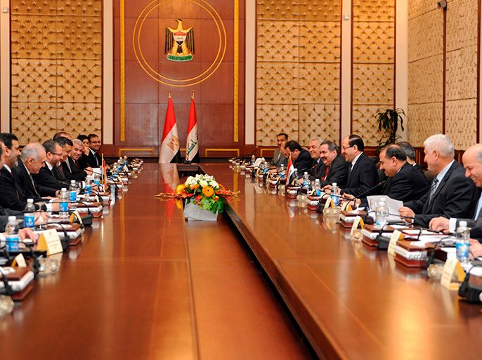 Iraq's Prime Minister Nuri al-Maliki meets with Egypt's Prime Minister Hisham Qandil and his delegation in Baghdad, in this March 4, 2013 picture provided by Iraqi Prime Minister Media Office. REUTERS/Iraqi Prime Minister Media Office/Handout (IRAQ - Tags: POLITICS) ATTENTION EDITORS - THIS IMAGE WAS PROVIDED BY A THIRD PARTY. FOR EDITORIAL USE ONLY. NOT FOR SALE FOR MARKETING OR ADVERTISING CAMPAIGNS. THIS PICTURE IS DISTRIBUTED EXACTLY AS RECEIVED BY REUTERS, AS A SERVICE TO CLIENTS
