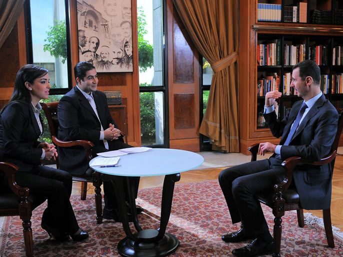 A handout picture released by the Syrian Arab News Agency (SANA) on April 17, 2013, shows Syrian President Bashar al-Assad (R) speaking during an interview in Damascus with Syria's state television channel Al-Ikhbariya, as the country marks Independence Day, celebrating the 1946 end of France's presence in Syria. Assad warned Western states that they will pay a heavy price at home for their alleged support of Islamists in the Syrian conflict and said defeat of his regime was not an option.
