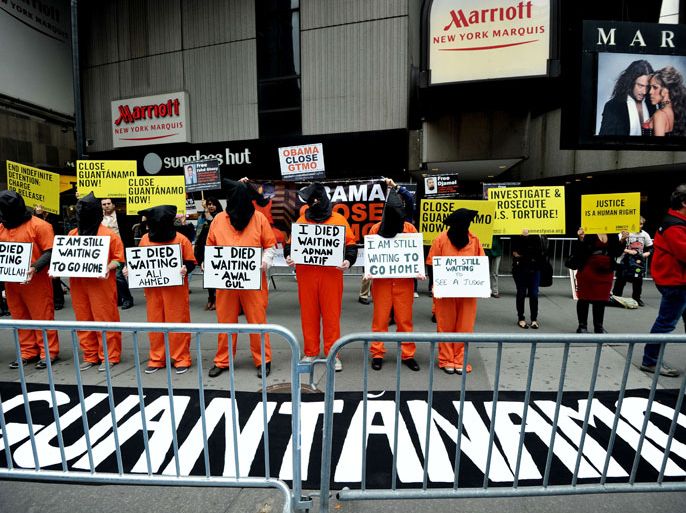 Activists demand the closing of the US military's detention facility in Guantanamo during a protest, part of the Nationwide for Guantanamo Day of Action, April 11, 2013 in New York's Times Square. The Guantanamo jail, in a US Navy base in Cuba, was opened in 2002 to hold prisoners taken in the "War on Terror" waged by then US President George W. Bush after the 9/11 attacks