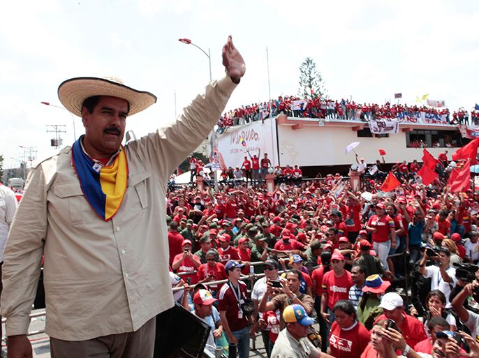 Venezuela's acting President and presidential candidate Nicolas Maduro waves to supporters during a campaign rally in the state of Cojedes April 4, 2013, in this picture provided by the Miraflores Palace. Venezuelans will vote in presidential elections on April 14. REUTERS/Miraflores Palace/Handout (VENEZUELA - Tags: POLITICS) ATTENTION EDITORS - THIS IMAGE WAS PROVIDED BY A THIRD PARTY. FOR EDITORIAL USE ONLY. NOT FOR SALE FOR MARKETING OR ADVERTISING CAMPAIGNS. THIS PICTURE IS DISTRIBUTED EXACTLY AS RECEIVED BY REUTERS, AS A SERVICE TO CLIENTS