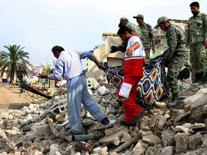 Iranian soldiers and aid workers help a man to carry his belongings salvaged from the rubble of his destroyed house in the town of Shonbeh, southeast of Bushehr, on April 10, 2013, a day after a powerful earthquake struck near the Gulf port city of Bushehr. Rescuers wound up operations after pulling 20 people from the rubble of a 6.1 magnitude earthquake, killing 37 people but sparing Iran's sole nuclear power plant.