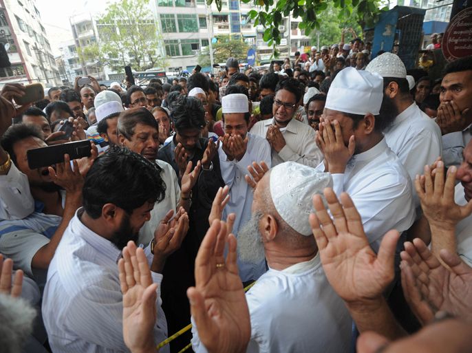 people pray for school victims in front of the Islamic school