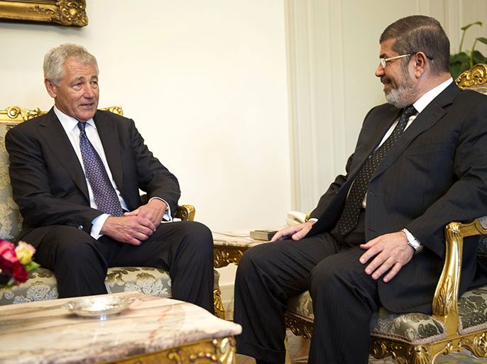 epa03675264 US Secretary of Defense Chuck Hagel (L) speaks with Egypt's President Mohamed Morsi at the Presidential Palace in Cairo, Egypt, 24 April 2013. US Defence Secretary Chuck Hagel arrived in Cairo on 24 April for talks expected to focus on the Syrian conflict and Iran, according to Egyptian officials. Hagel was to meet with military and civilian officials during his visit to Egypt, part of a five-nation regional tour, added the officials. EPA/JIM WATSON/POOL