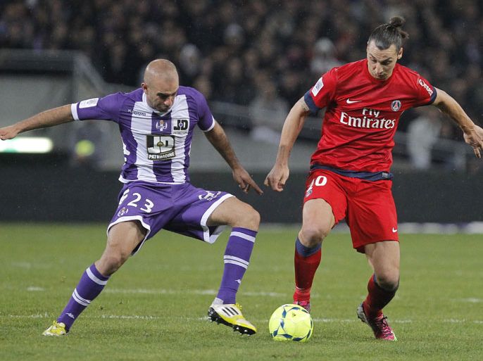 epa03564461 Zlatan Ibrahimovic (R) of Paris Saint Germain vies for the ball with Aymen Abdennour (L) of Toulouse Football Club during their soccer league one match between Paris Saint Germain and Toulouse in Toulouse Southern France 01 February 2013. EPA/GUILLAUME HORCAJUELO