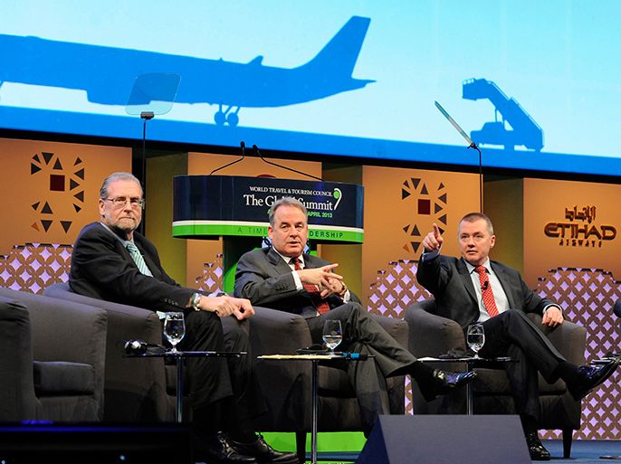 James Hogan (C), Etihad's chief executive, and International Airlines Group (IAG) CEO Willie Walsh (R) gestures during the Global Summit meeting at Etihad towers in Abu Dhabi, April 10, 2013. Etihad Airways' purchase of a stake in India's Jet Airways could be delayed until at least August as the Abu Dhabi carrier seeks assurances following setbacks for several Gulf investors in India, two sources familiar with the talks said. REUTERS/Ben Job (UNITED ARAB EMIRATES - Tags: BUSINESS TRANSPORT)