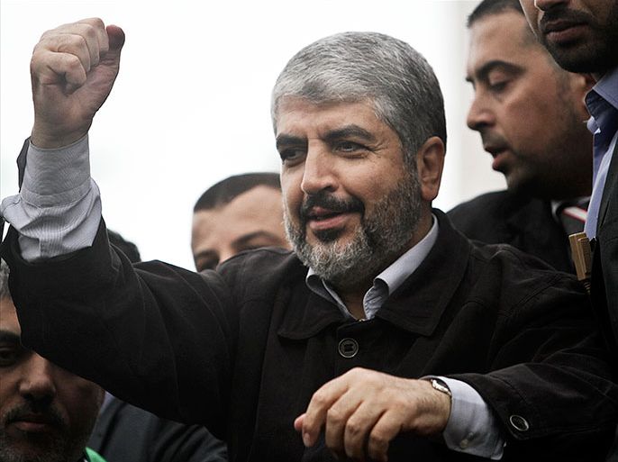 epa03501729 Exiled Hamas leader Khaled Meshaal attends the 25th anniversary of the ruling party of the Gaza Strip Hamas in Gaza City, 08 December 2012. Tens of thousands of Palestinians gathered in a central Gaza City square to celebrate the 25th anniversary of the Islamist Hamas movement. The square's decoration includes a huge stage, showing a model of an M-75 rocket,