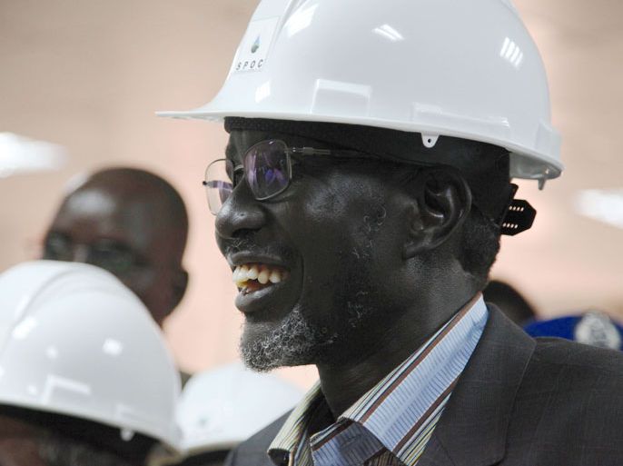 SOUTH SUDAN : South Sudan's Minister for Petroleum and Mining Stephen Dhieu Dau smiles in an oil mining control centre in Thar Jath on April 6, 2013 after restarting oil production. South Sudan restarted oil production on April 6, ending a bitter 15-month row with former civil war foe Sudan and marking a major breakthrough in relations after bloody border clashes last year. AFP PHOTO / HANNAH MCNEISH