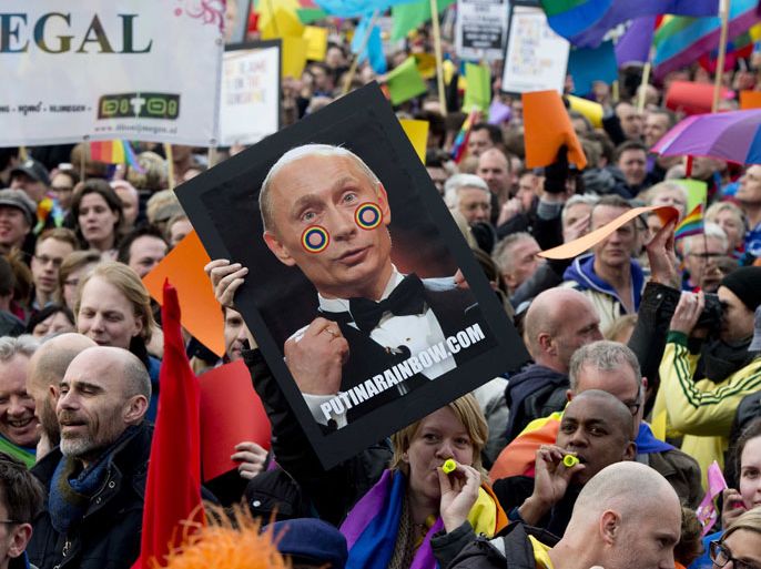 Over 1,000 people protest against Russian President Vladimir Putin's visit to Amsterdam on April 8, 2013, with rainbow flags flying at half-mast around the city that prides itself on enjoying every kind of freedom.