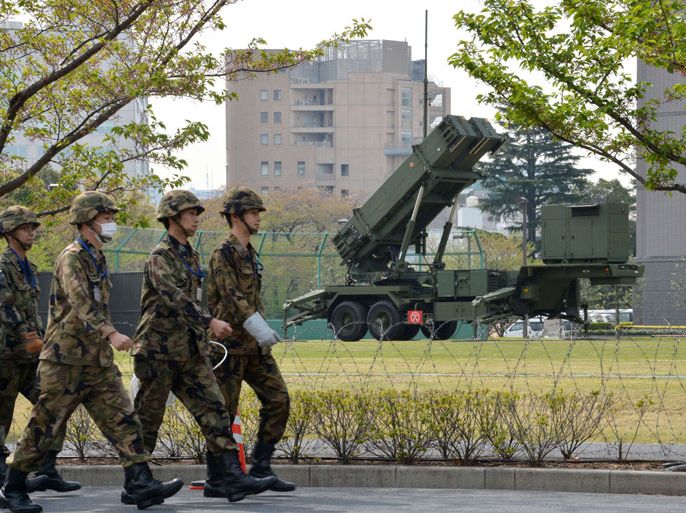 Officers of Japan's Ground Self-Defense Force (SDF) walk in front of Patriot Advanced Capability-3 (PAC-3) surface-to-air missile launchers at the Defence Ministry in Tokyo on April 9, 2013. Japan has deployed Patriot missiles in its capital as it readies to defend the 30 million people who live in greater Tokyo from any North Korean attack