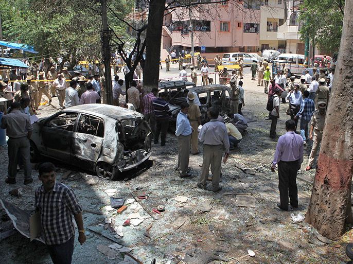 Indian police gather at the scene of a blast near the Bharatiya Janata Party (BJP) office in Bangalore on April 17, 2013. Police in the southern city of Bangalore said Wednesday they were investigating a minor blast outside the office of a political party which injured 12 people. AFP PHOTO/STR