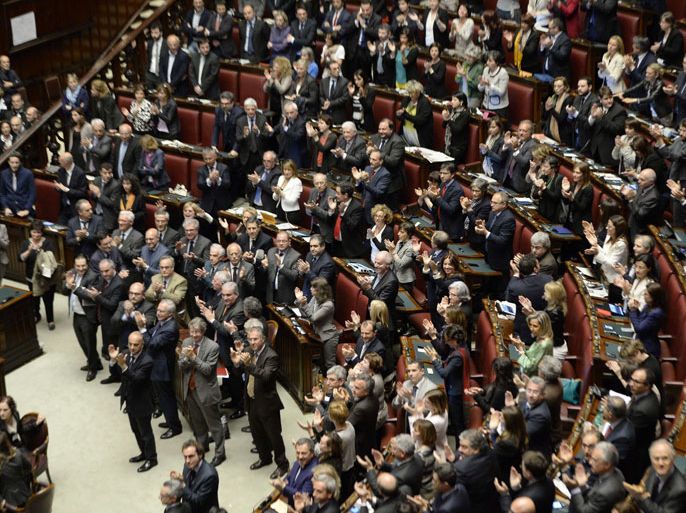 Italian Deputies and Senators applaud in the Italian Parliament in Rome on April 20, 2013 after Italian President Giorgio Napolitano was confirmed re-elected. Italy's 87-year-old President Giorgio Napolitano said on Saturday said he would run for a second term despite earlier ruling out the prospect, following an appeal from the main parties to help defuse an increasingly tense political crisis. "I consider it necessary to offer my availability," Napolitano said in a statement, as bickering lawmakers prepared for a sixth round of voting in parliament that he is now expected to win by a large margin. AFP PHOTO / ANDREAS SOLARO