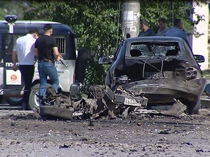 A video grab made on May 20, 2013 shows a blast site outside a building used by court bailiffs in central Makhachkala. At least eight people were killed and more than a dozen injured today in twin car blasts outside a court building in the southern Russian city of Makhachkala in the restless region of Dagestan. AFP PHOTO / ACHMED ACHMEDOV