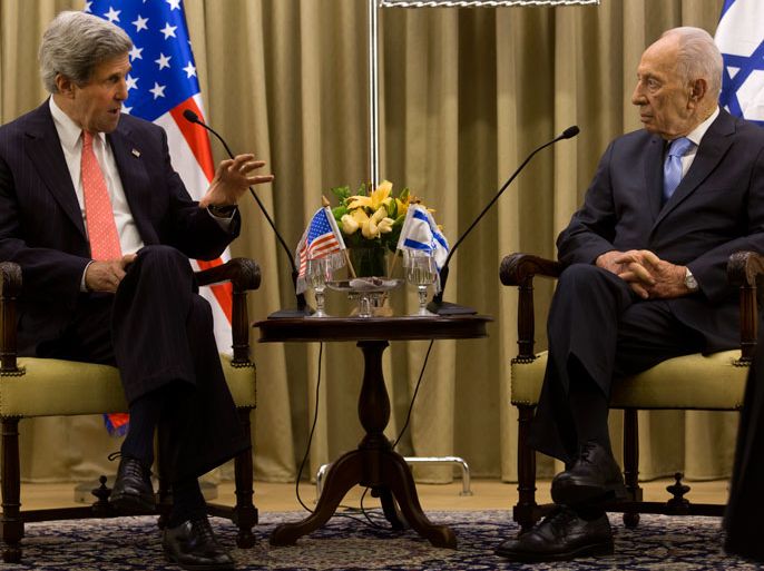 US Secretary of State John Kerry (L) speaks about the US role in trying to help Israeli and Palestinians find a way to direct peace talks as he meets with Israeli President Shimon Peres (R) in the elder statesman's Jerusalem residence, 23 May 2013. Kerry met with both the Israeli and Palestinian leadership on 23 May in hopes of restarting the direct peace talks between the two sides. EPA/JIM HOLLANDER / POOL