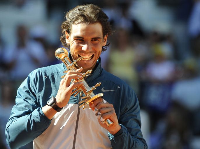 Spanish player Rafael Nadal poses with his trophy after winning the men's singles final tennis match of the Madrid Masters against Swiss player Stanislas Wawrinka at the Magic Box (Caja Magica) sports complex in Madrid on May 12, 2013. Nadal won the match 6-2, 6-4. AFP PHOTO / DOMINIQUE FAGET