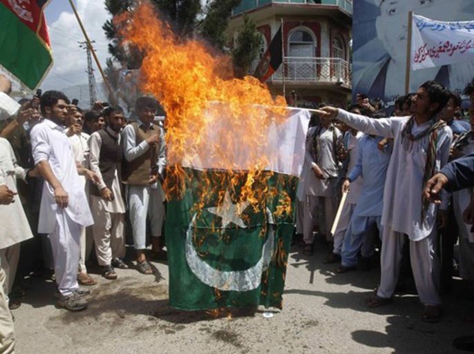 PARWIZ/REUTERS - Afghan protesters set fire to a Pakistan flag during a demonstration against recent border clashes between Afghanistan and Pakistan