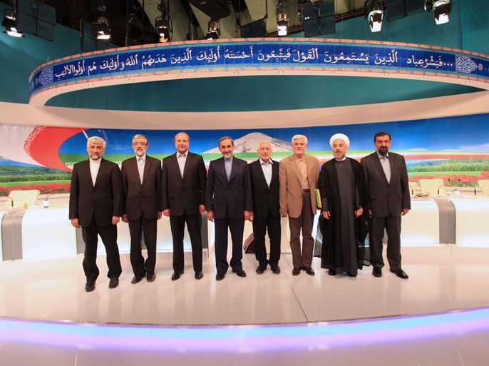 Iranian presidential candidates, (From L to R) top nuclear negotiator Saeed Jalili, former parliament speaker Gholam-Ali Haddad Adel, Tehran's mayor Mohammad Baqer Qalibaf, former foreign minister Ali Akbar Velayati, Mohammad Qarazi, former first vice president Mohammad Reza Aref, former chief nuclear negotiator Hassan Rowhani and former chief of the Revolutionary Guards Mohsen Rezai pose for a group photo after their live debate on state TV in Tehran on May 31, 2013. A televised debate on Iran's sanctions-hit economy today failed to introduce a frontrunner as the eight approved presidential candidates echoed each other on the main issues and refrained from making direct attacks. The debate, the first of three organised by state television ahead of the June 14 election, lasted four hours and focused on the economic policies of the candidates. AFP PHOTO / MEHDI DEHGHAN