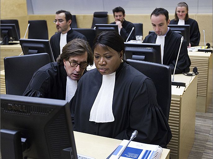 International Criminal Court (ICC) Prosecutor Fatou Bensouda (R) and senior trial lawyer Eric Mac Donald (L) talk on February 19, 2013 before the start of the hearing of former Ivory Coast President Laurent Gbagbo before the ICC in The Hague. The ICC will decide whether there is enough evidence to try Gbagbo for masterminding a bloody election standoff two years ago. Gbagbo, 67, the first-ever former head of state to appear before the ICC, faces four counts of crimes against humanity including murder and rape for fomenting a wave of violence which swept the west African nation after he refused to concede defeat in November 2010 presidential polls. AFP PHOTO / POOL / MICHAEL KOOREN