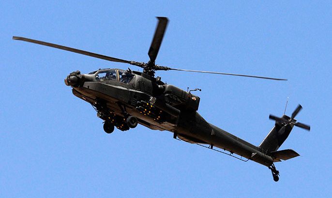 An Egyptian Apache helicopter flies in the direction towards al-Jura district in El-Arish city from Sheikh Zuwaid, around 350 km (217 miles) northeast of Cairo May 21, 2013. Egypt's army and police stepped up roadblocks in an area of northern Sinai as they tried to track down militant Islamists who kidnapped seven security officers last week, a security source said on Tuesday. REUTERS/Stringer (EGYPT - Tags: POLITICS MILITARY)