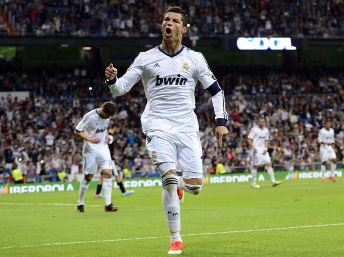 Real Madrid's Portuguese forward Cristiano Ronaldo celebrates after scoring their second goal during the Spanish league football match Real Madrid CF vs Malaga CF at the Santiago Bernabeu stadium in Madrid on May 8, 2013. AFP PHOTO/ JAVIER SORIANO