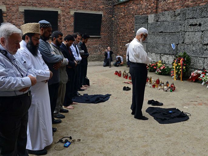 Muslim religious leaders from across the globe pray in front of so-called death wall at the Nazi death camp Auschwitz-Birkenau as part of an anti-genocide programme on May 22, 2013. Muslim religious leaders from across the globe met with Holocaust survivors in an emotional encounter at Warsaw's synagogue, as part of an anti-genocide programme that includes a visit to Auschwitz