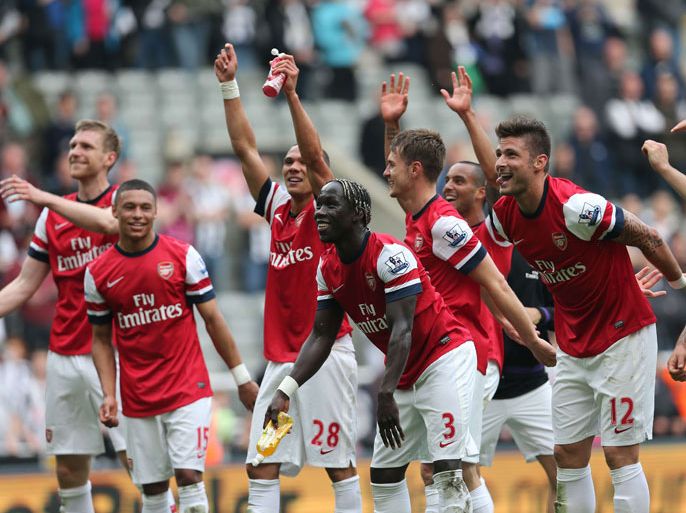Arsenal players celebrate their victory after the final whistle in the English Premier League football match between Newcastle United and Arsenal at St James' Park in Newcastle Upon Tyne, northeast England, on May 19, 2013. Arsenal won the race for fourth place in the Premier League with a 1-0 victory at Newcastle. AFP PHOTO / IAN MACNICOL