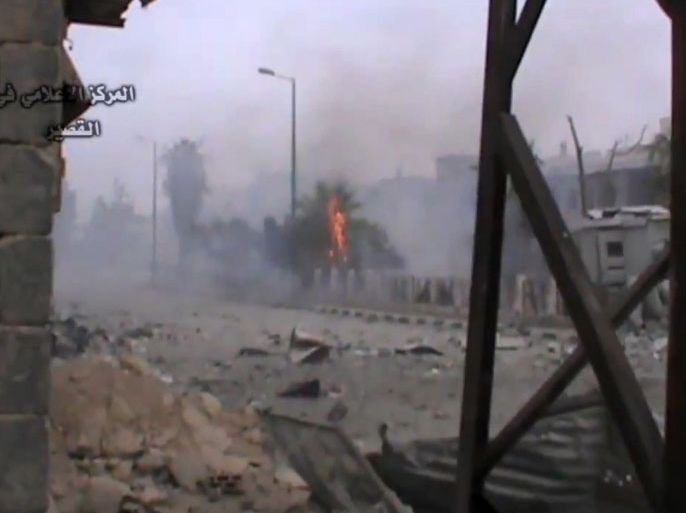 A image grab taken from a video uploaded on Youtube by Al-Qusayr Media Centre on May 24, 2013 shows smoke rising from the site of an alleged rocket attack in the city of Qusayr, in Syria's central Homs province. Syrian troops have captured much of the rebel stronghold of Qusayr, in central Homs province, squeezing opposition fighters into the north of the strategic town, a military officer told AFP. AFP PHOTO / HO /AL-QUSAYR MEDIA CENTRE