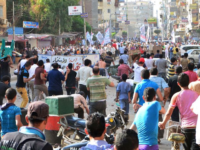YPT : Egyptian anti-government protesters (foreground) clash with pro-government protesters (background) in the Nile Delta city of Mansura, 120 kms north of Cairo, on June 26, 2013, which left at least one person was killed and 237 hurt, the health ministry said