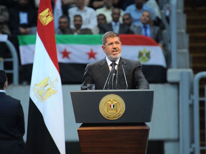 Cairo, -, EGYPT : In this hand out picture released by the Egyptian Presidency Egyptian President Mohammed Morsi gives his speech to thousands of islamists and Syrian opposition supporters during the "support for Syria" rally at Cairo stadium on June 15, 2013 in Cairo, Egypt. Egypt's Islamist President Mohammed Morsi on Saturday announced the "definitive" severing of relations with war-torn Syria, which is suffering from more than two years of civil war. Egypt "decided today to definitively break off relations with the current regime in Syria, to close that regime's embassy in Cairo and to recall Egypt's charge d'affaires" from Damascus, Morsi told thousands of Islamist supporters in a Cairo stadium for a "Support for Syria" rally.