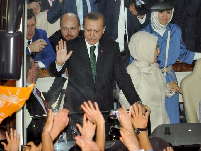 DEC315 - Istanbul, -, TURKEY : Turkish Prime Minister Recep Tayyip Erdogan (L), wife Emne Erdogan (C) and daugther Sumeye Erdogan (R) are greeted by supporters upon arrival at Ataturk International Airport in Istanbul on June 7, 2013.Turkey's Islamic-rooted government apologised to wounded protestors and said it had "learnt its lesson" after days of mass street demonstrations that have posed the biggest challenge to Prime Minister Recep Tayyip Erdogan's decade in office. Turkish police had on June 1 begun pulling out of Istanbul's iconic Taksim Square, after a second day of violent clashes between protesters and police over a controversial development project. What started as an outcry against a local development project has snowballed into widespread anger against what critics say is the government's increasingly conservative and authoritarian agenda. AFP PHOTO / OZAN KOSE