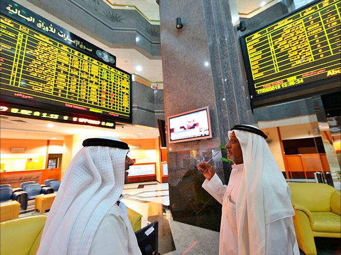 Investors speak as they monitor stocks at the Abu Dhabi Securities Exchange, June 17, 2013. The United Arab Emirates has revived a proposal to merge its two main stock exchanges in a state-backed deal that could boost trade in the local market and attract more foreign investment to the Gulf state, sources familiar with the plan said. REUTERS/Ben Job (UNITED ARAB EMIRATES - Tags: BUSINESS)