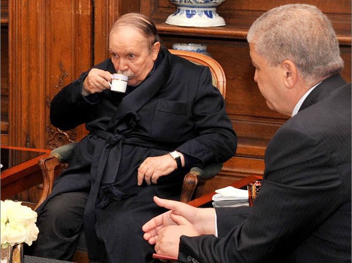 A photo obtained from Algerian Press Service (APS) news agency shows Algeria's President Abdelaziz Bouteflika (C) drinking tea as he receives Algeria's Prime Minister Abdelmalek Sellal (R) and Chief of Staff Ahmed Gaid Salah (unseen) in a Paris hospital on June 12, 2013 in one of the first pictures to emerge since he was hospitalised in France in April after a mini-stroke. Pictures of Bouteflika were published by the APS to dispel rumours circulating in both Algiers and Paris about the 76-year-old president's condition deteriorating. AFP PHOTO / APS / STR
