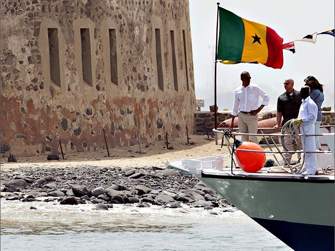 US President Barack Obama arrives by boat to tour Goree Island, including the House of Slaves, or Maison des Esclaves, off the coast of Dakar on June 27, 2013. Obama and his family toured the museum at the site where African slaves were held before going through the door and being shipped off the continent as slaves. AFP PHOTO / Saul LOEB