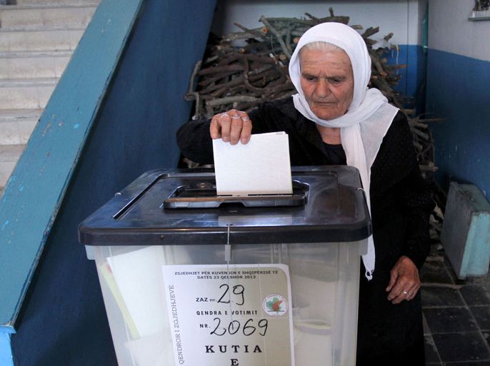 An Albanian woman casts her vote at a polling station in the village of Fushas, near Tirana on June 23, 2013. Albanians began voting on Sunday for a crucial vote that could determine whether one of Europe's poorest countries has a chance of joining the European Union in the foreseeable future. An opposition activist was killed in an apparently politically motivated shooting in Albania on June 23 during the election.
