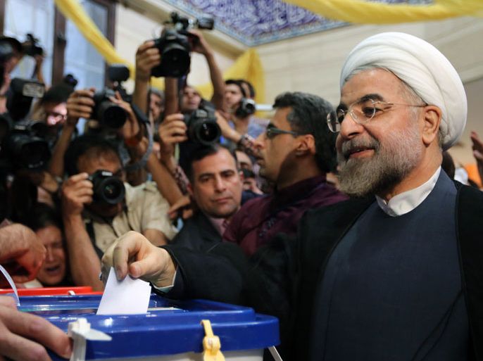 Tehran, -, IRAN : Iranian moderate presidential candidate, Hassan Rowhani casts his vote at a polling station in Tehran on June 14, 2013 during the first round of the presidential election. Iranians are voting to choose a new president in an election the reformists hope their sole candidate will win in the face of divided conservative ranks, four years after the disputed re-election of Mahmoud Ahmadinejad. AFP PHOTO/ATTA KENARE