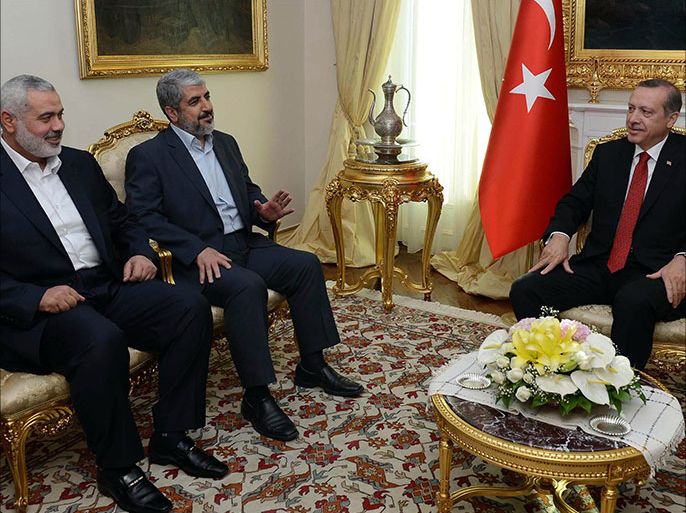 Turkish Prime Minister Recep Tayyip Erdogan (R) meets Khalid Mashaal (C), the Hamas chief in exile, and Gaza’s prime minister Ismail Haniyeh in Ankara on June 18, 2013. Senior leaders of the Palestinian Islamist movement Hamas met today in Ankara with Turkish Prime Minister Erdogan to discuss Erdogan's planned visit to the Gaza Strip as well as the situation in Syria, the source said on condition of anonymity. AFP PHOTO/ PRIME MINISTER PRESS OFFICE/ YASIN BULBUL