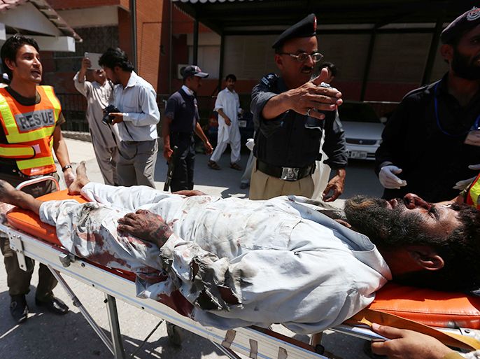 epa03754080 A man who was injured in a suicide bomb attack at a Mosque, is rushed on a stretcher to a hospital in Peshawar, Pakistan, 21 June 2013. At least 10 people were killed and more than 15 injured on 21 June in a suicide bombing inside a Shiite mosque in Pakistan's troubled north-western region, officials said. The incident occurred in Gulshan Colony in the suburbs of Peshawar, the capital of Khyber-Pakhtunkhwa province, as worshippers were preparing for Friday prayers. EPA/BILAWAL ARBAB