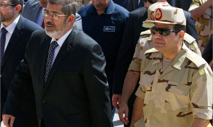 epa03756938 (FILE) A file photo dated 22 May 2013 shows Egyptian President Mohamed Morsi (L) and Egyptian Minister of Defense Abdel-Fattah al-Sissi (R) arriving to meet seven Egyptian security personnel, who were released by unknown kidnappers in the Sinai Peninsula, at Al-Maza military airport in Cairo, Egypt. Al-Sissi on 23 June 2013 said the Egyptian army will not allow competing political factions to tear the country apart, adding the military is prepared to intervene if ongoing political turmoil flares out of control. The statement comes as the country braces for rival protests next week in the run-up to the one-year anniversary of President Mohamed Morsi's taking office, on 30 June. EPA/KHALED ELFIQI