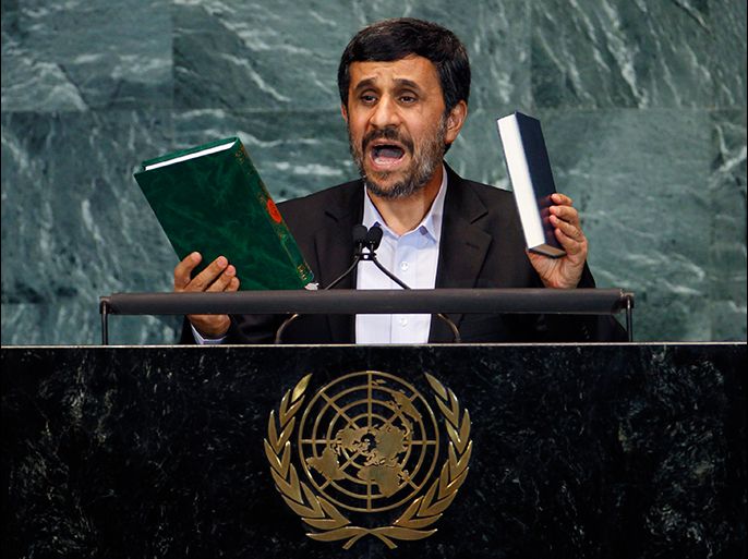 Iran's President Mahmoud Ahmadinejad holds up copies of the Koran (L) and the Bible as he addresses the 65th United Nations General Assembly at the U.N. headquarters in New York in this September 23, 2010 file picture.
