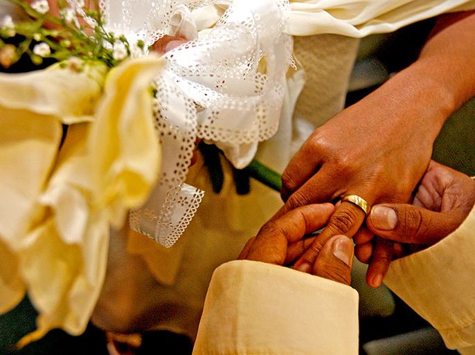 A Filipino couple exchange rings during a mass wedding ceremony in Makati City, southern Manila, Philippines on 05 June 2009. More than 30 couples were wed in a mass wedding ceremony sponsored by the local government. EPA/ALANAH M. TORRALBA