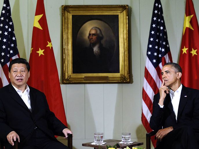US President Barack Obama (R) listens as Chinese President Xi Jinping answers a question following their bilateral meeting at the Annenberg Retreat at Sunnylands in Rancho Mirage, California, on June 7, 2013.Obama, with Chinese counterpart Xi Jinping by his side, called Friday for common rules on cybersecurity after allegations of hacking by Beijing. At a summit in the Calfornia desert, Obama said it was "critical" to reach a "permanent understanding" on cybersecurity.